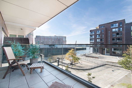 Sonniger Balkon mit Blick auf Wasser und urbane Umgebung