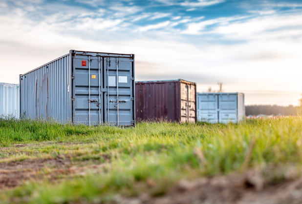 Einige mobile Container stehen auf einer Wiese.