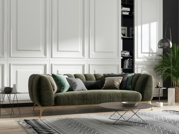 Ein dunkelgrünes modernes Sofa in einem hellen Wohnzimmer.
