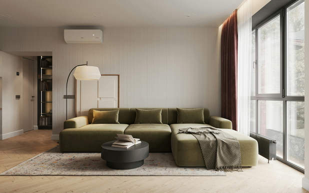 Ein modernes Wohnzimmer mit einer großen dunkelgrünen Couch.