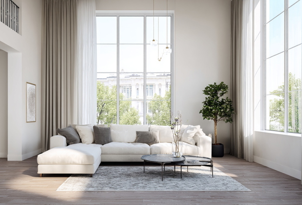 Eine helles und modernes Wohnzimmer mit hohen Decken und einer weißen Couch.